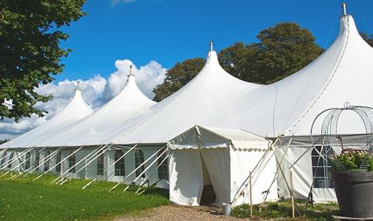 a row of green and white portable restrooms at an outdoor event venue in Glen Ellen, CA